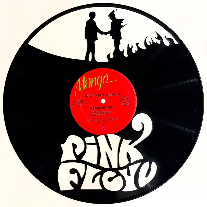 A custom laser cut vinyl record, the Pink Floyd wordmark and the burning handshake cut through the disc