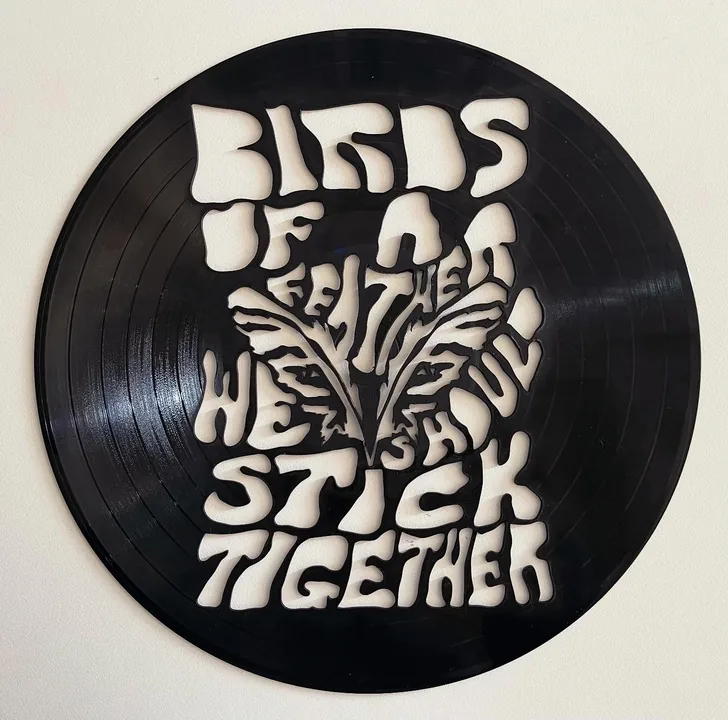 A vinyl record with the lyric Birds of a feather we should stick together cut through it